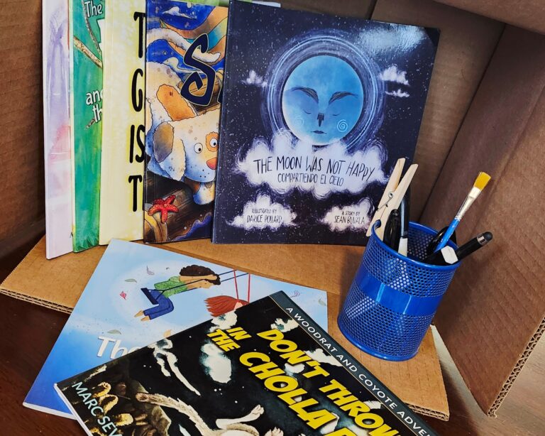 8 childrens books in a box making up a home library